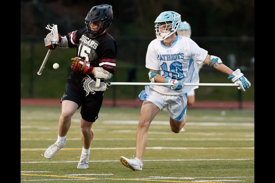 Yorktown's Vinny Spolidoro attempts to get the ball away from Oakton defenseman Ryan Dowling.