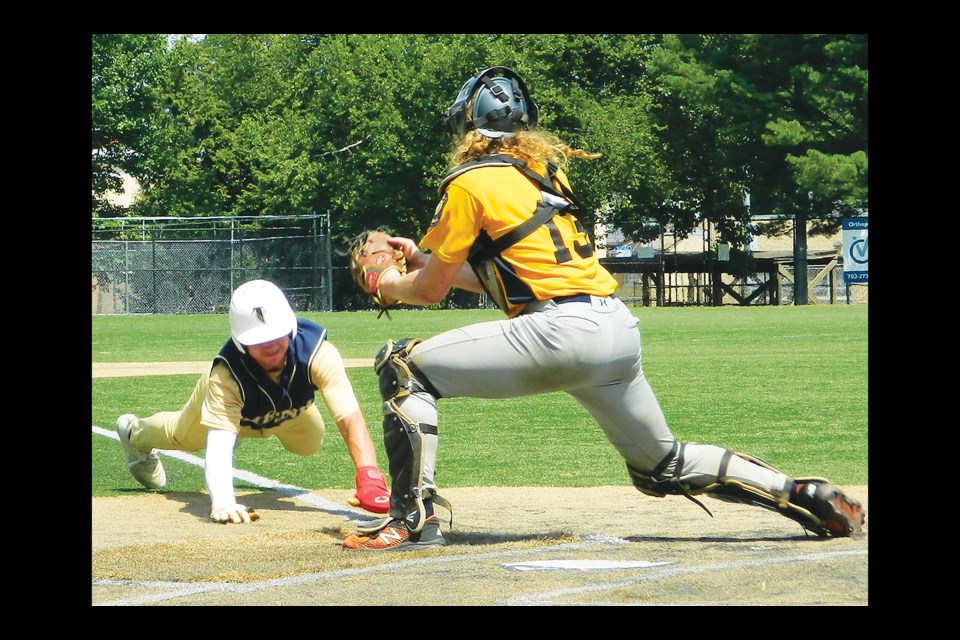 Drew Hall of Vienna Post 180 is tagged out at home by catcher Harold Heller of Falls Church Post 130 in the District 17 all-star game. 