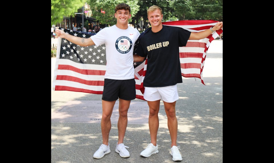 Picture of Greg Duncan and Tyler Downs wrapped in the American Flag