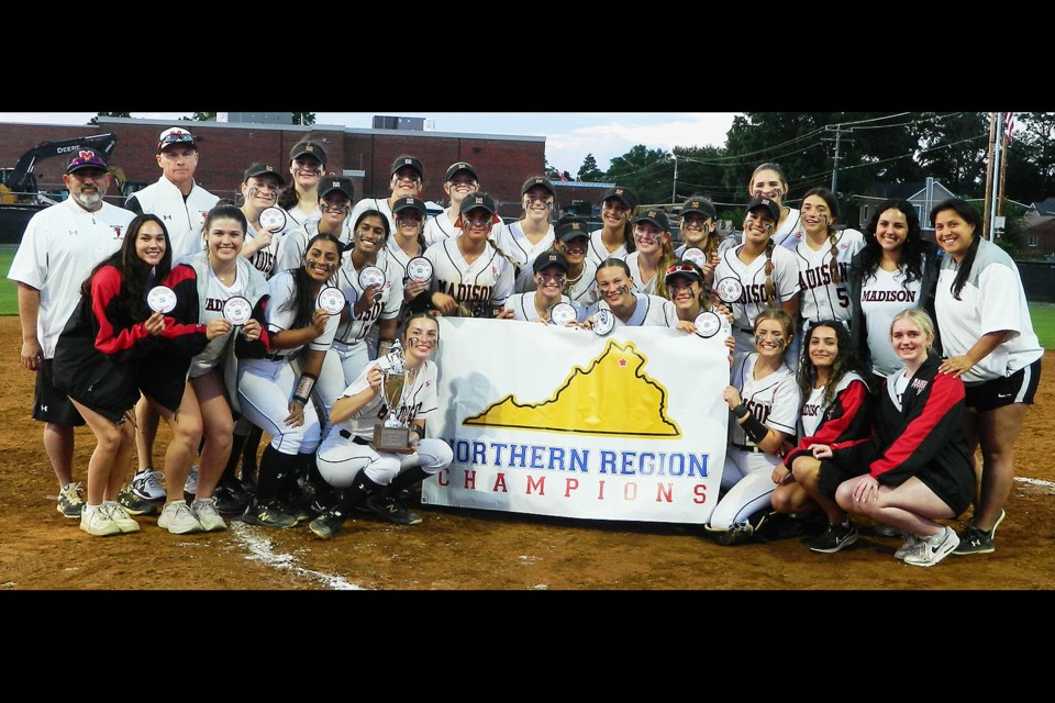 The Madison Warhawks gather with the region championship banner and trophy.