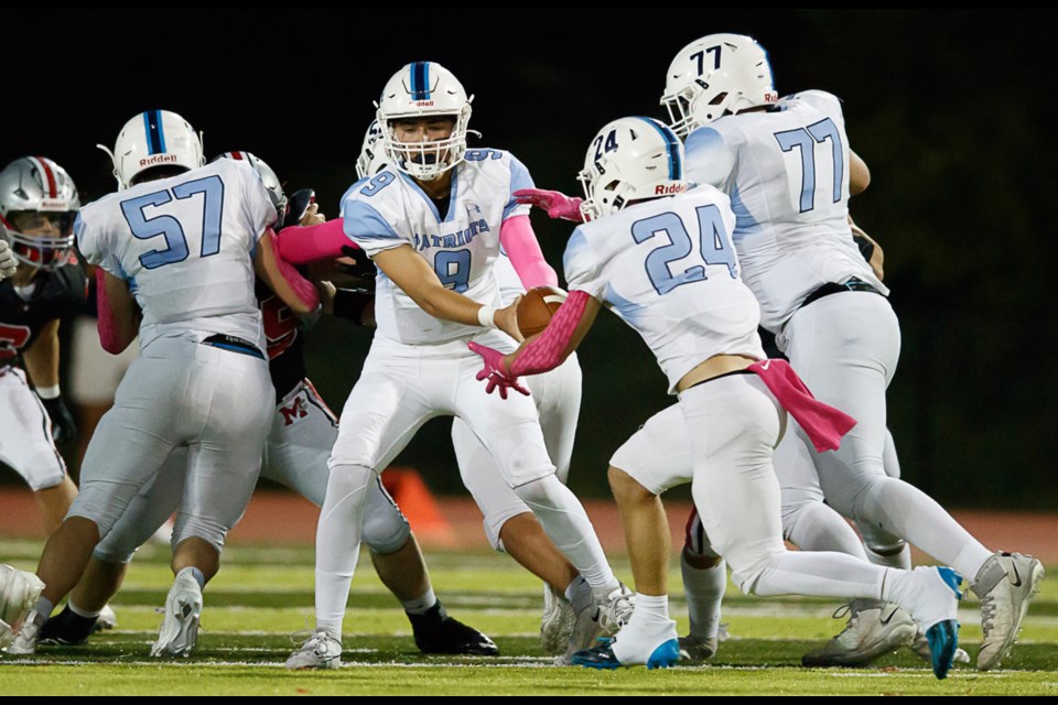 Yorktown quarterback Drew Morgan hands off to Coby Casalengo.