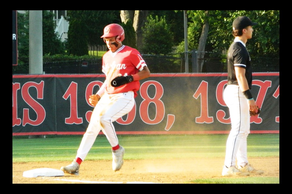 McLean's Gabe Pegues reaches third base and later scored in the first inning of a region-semifinal game.