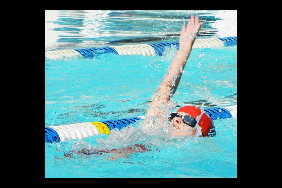 Owen Walsh of Dominion Hills swims the backtroke during his team's opening week of the Northern Virginia Swimming League's summer season.