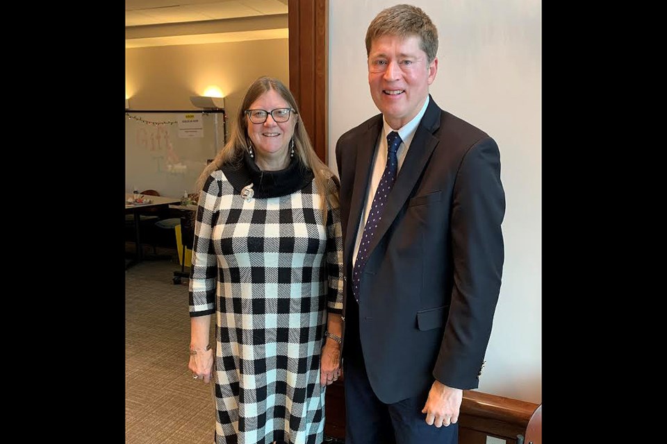 Arlington Circuit Court Chief Judge Judith Wheat poses with Clerk of the Circuit Court Paul Ferguson after the former swore in the latter for a new term in office.