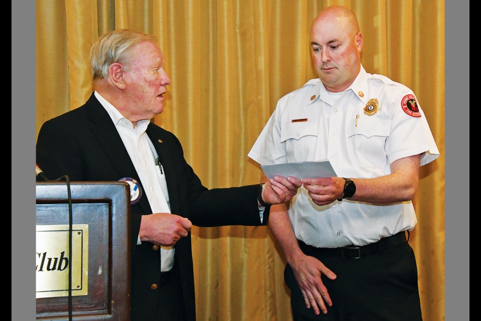 Rotary Club of Vienna member George Creed presents Vienna Volunteer Fire Department Chief John Morrison with a check during the club's April 19, 2023, luncheon at Westwood Country Club. 