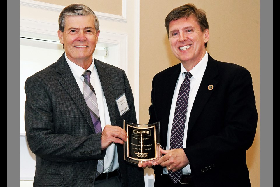 Dr. Eric Goplerud accepts the 2024 Hunter Mill District Community Champion award from Supervisor Walter Alcorn (D-Hunter Mill) May 9 at the Volunteer Service Awards, held at the Country Club of Fairfax. 