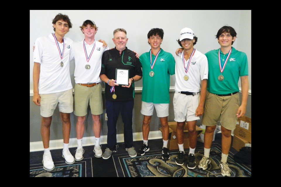 Members of the Wakefield High School golf team gather with the first-place trophy and medals after winning the South County Invitational tournament. 