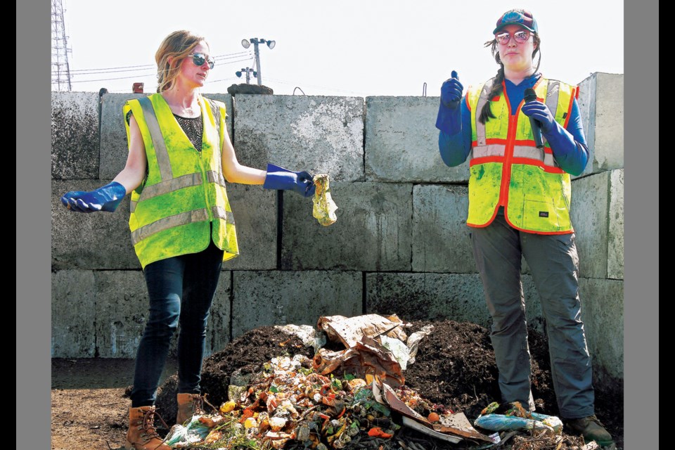 Kristie Blumer and Julie Williamson from contractor Compost Crew give a primer on what items may and may not be composted April 5, 2023, during the ceremonial kickoff of the "Compost Outpost" pilot program at the county's I-66 Transfer Station in Fairfax. 