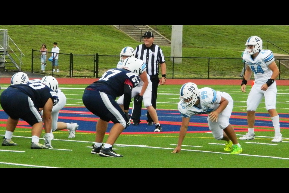 From left: Yorktown High School defensive players Hewitt Ebert, Aedan Kopiak, Bobby Shea and Ian O'Neal take their positions against Woodson.