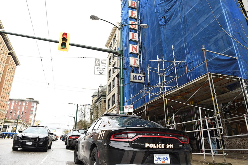 Police park on Hastings Street near the Regent Hotel, where a man was shot inside on the fifth floor March 14, 2017. Photo Dan Toulgoet