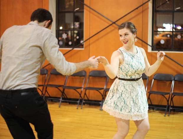 鶹ýӳSwing Society instructors Kelsey Savage and Walker Banerd warm up before teaching a swing dance group lesson at the Roundhouse Community
Centre, Dec. 15.