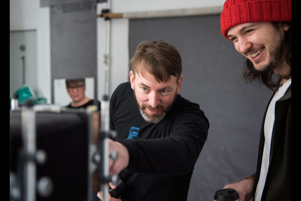 Photographer Ross den Otter explained his large format camera and his modifications to Photographer-Assisted Selfie subject Joel Laurino. Photo Rebecca Blissett