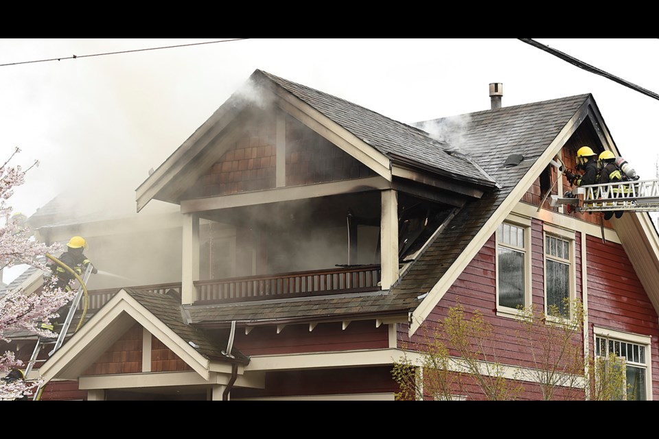 Firefighters continue to battle a blaze that appears to have started in the attic of a home at 1799 Charles St.