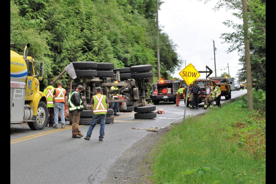 A logging truck rolled over and spilled its load at around 1:30 p.m. near the Muir Creek bridge in Shirley. Photograph by Rick Fonger