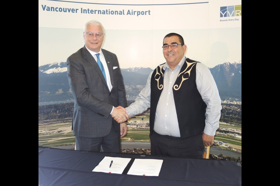 Musqueam Indian Band's Chief Wayne Sparrow (right) shakes hands with YVR's president and CEO Craig Richmond, moments after signing an historic, 30-year deal that will see the band getting scholarships, jobs and revenue from the airport