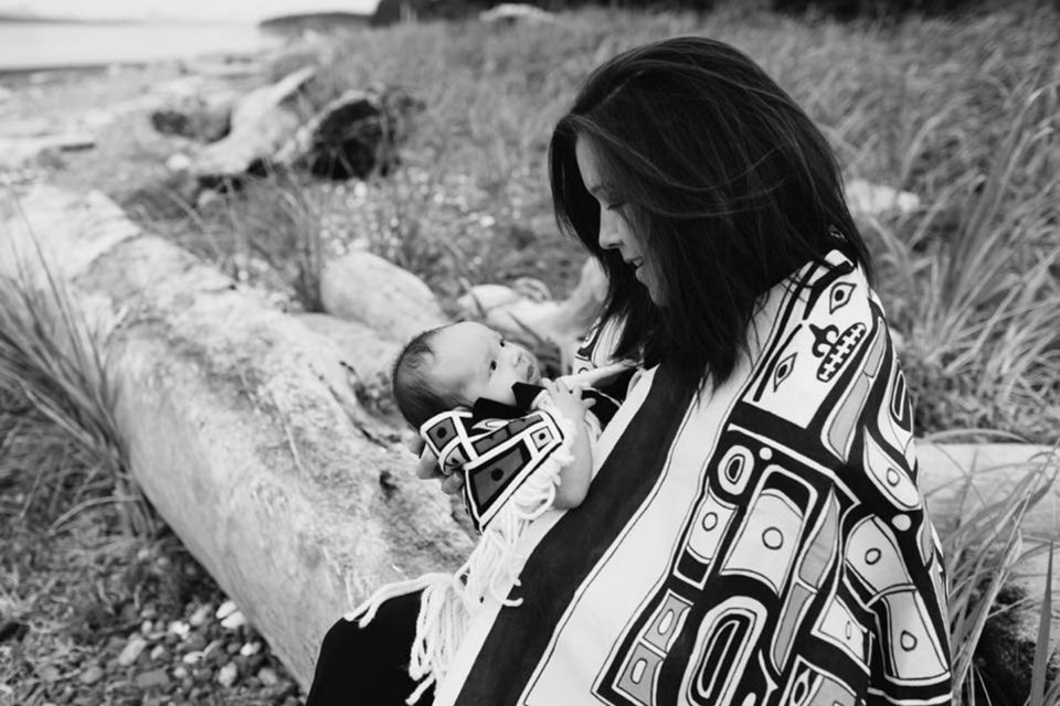 Ferrin Willie and one of her daughters in a custom Chilkat blanket that was stolen from their Port Hardy home.