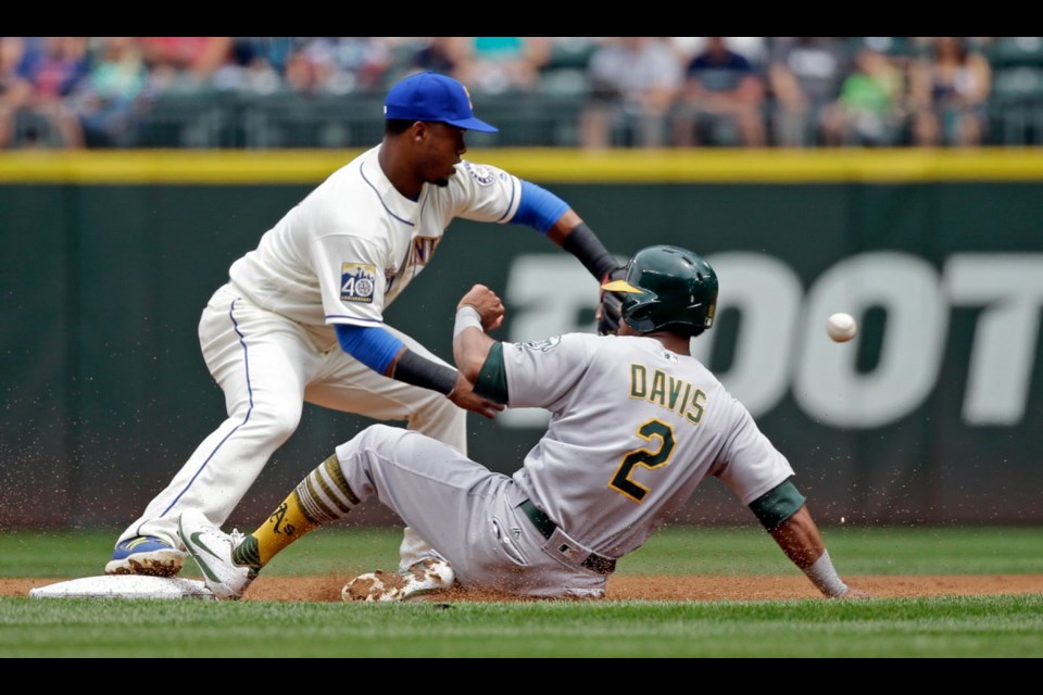 Oakland Athletics' Khris Davis (2) slides safely into second base as Seattle Mariners shortstop Jean Segura waits for the throw in the second inning of Sunday's game in Seattle. Davis was safe on the fielder's choice.