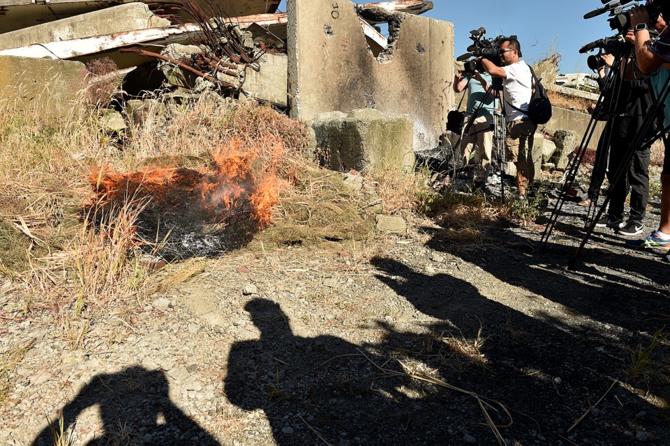 A grass fire was lit to show how quickly it starts from a thrown cigarette. Photo Dan Toulgoet