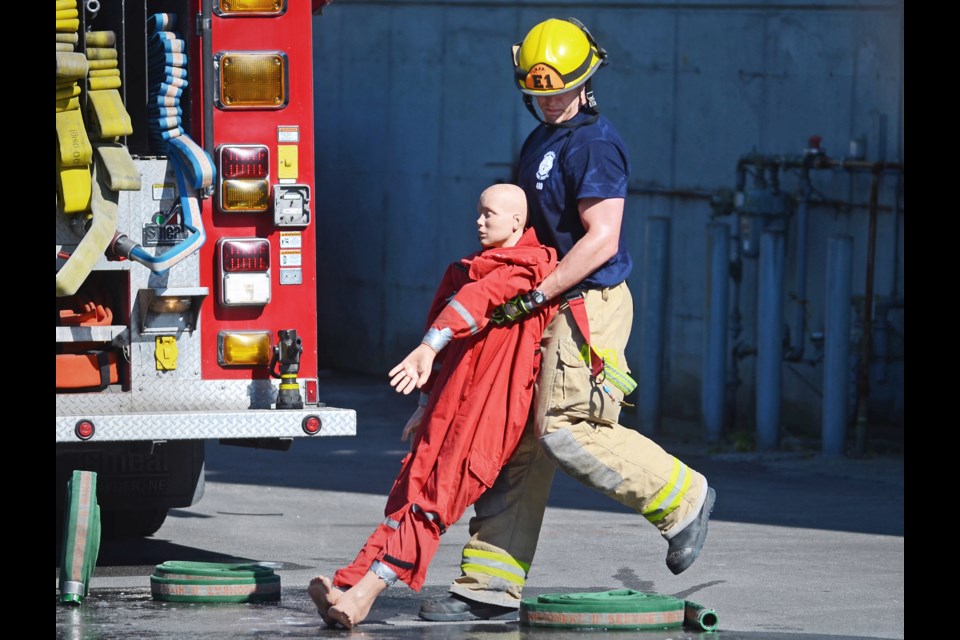 A Burnaby firefighter tidies up after recent demonstrations put on by the fire department's technical rescue team and rescue task force.