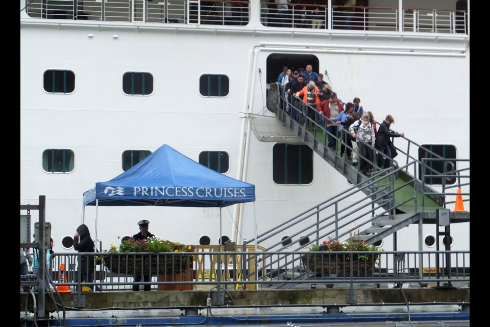 Passengers of the Emerald Princess cruise ship disembark on Wednesday, July 26, 2017, in Juneau, Alaska, hours after arriving at port. A domestic dispute aboard the cruise ship led to the death of a 39-year-old Utah woman, and the FBI is investigating what happened in U.S. waters off Alaska, the agency said.