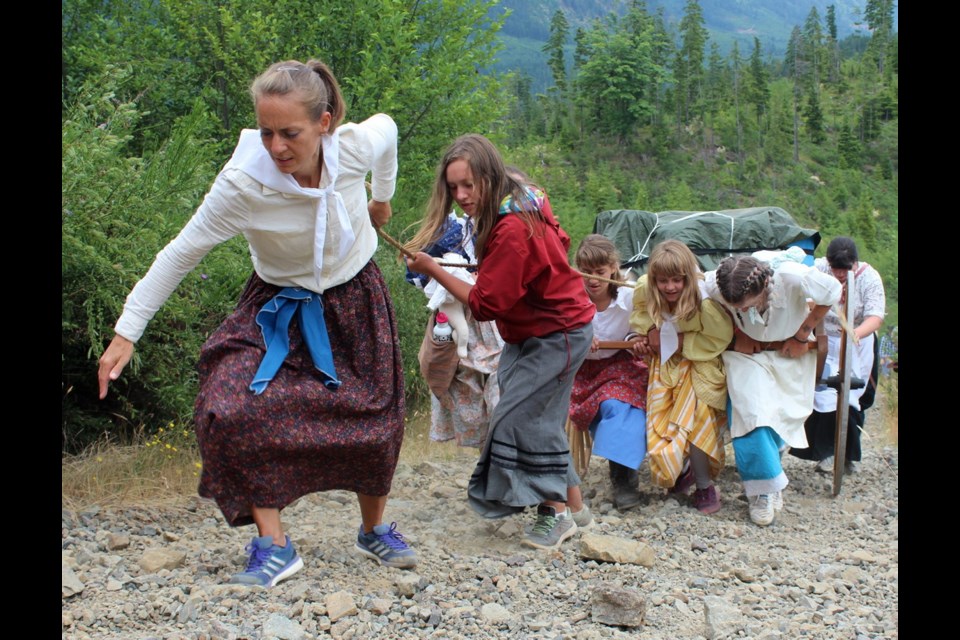 Young women and girls pull a handcart up a steep incline on a logging road near Lake Cowichan. They were among about 80 youths involved in a re-enactment of part of the Mormon migration across the Great Plains.