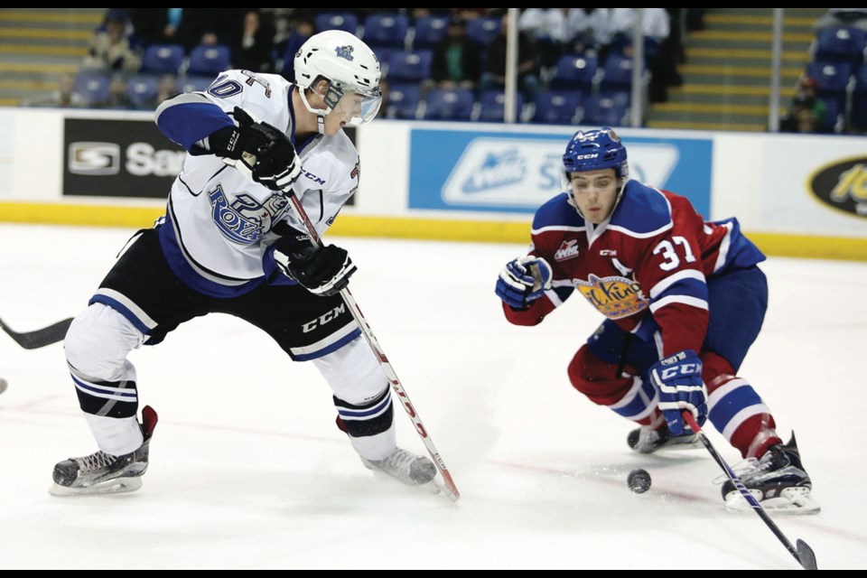 Ryan Peckford gets the puck past Edmonton Oil Kings defenceman Dysin Mayo.