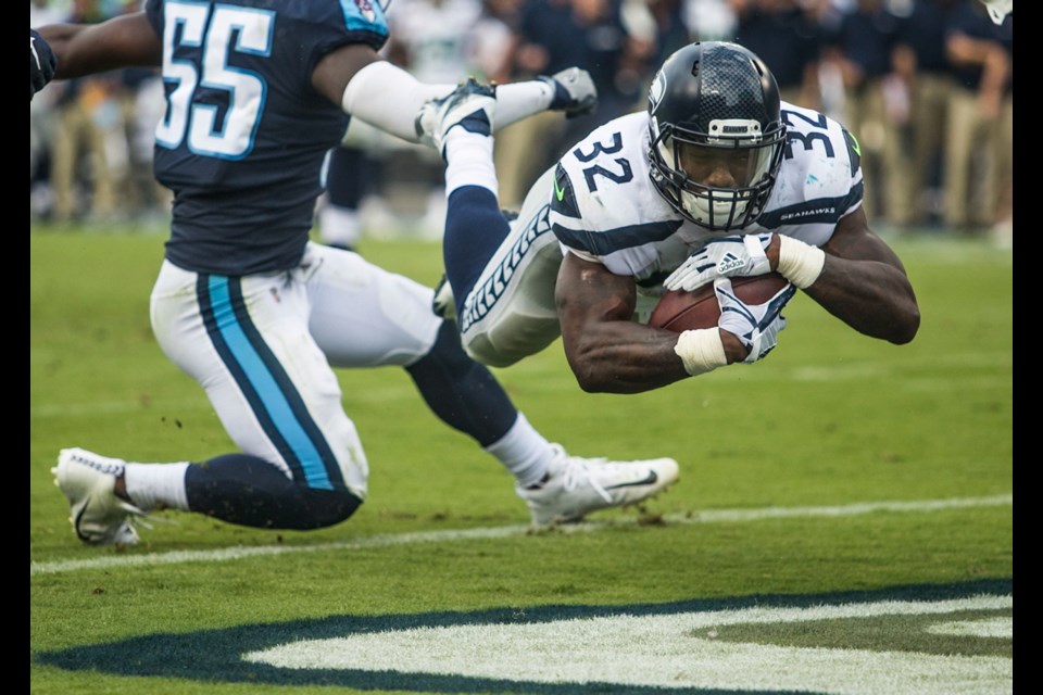 Seattle Seahawks running back Chris Carson (32) dives into the end zone for a touchdown against the Tennessee Titans during Sunday's game in Nashville, Tennessee.