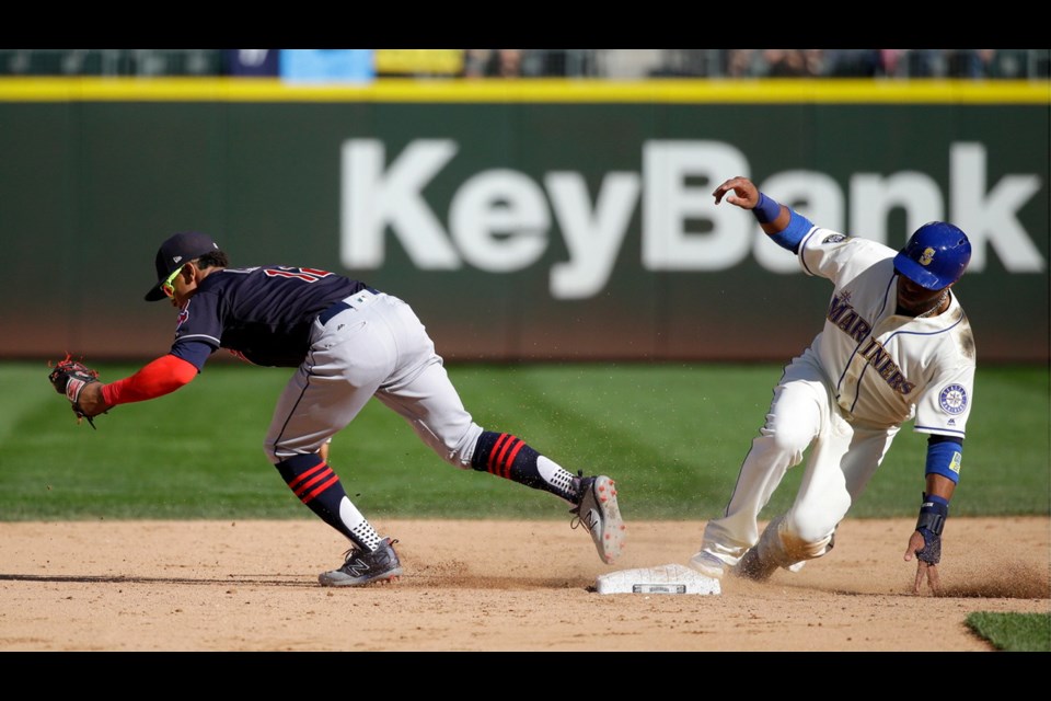 Seattle Mariners' Robinson Cano, right, is forced out at second by Cleveland Indians shortstop Francisco Lindor in the eighth inning of Sunday's game in Seattle. The Indians won 4-2.