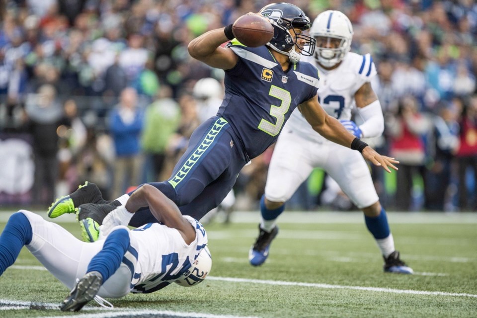 Seattle Seahawks quarterback Russell Wilson is sacked in the end zone by Indianapolis Colts cornerback Nate Hairston for a safety in the first quarter of Sunday's game at CenturyLink Field in Seattle.