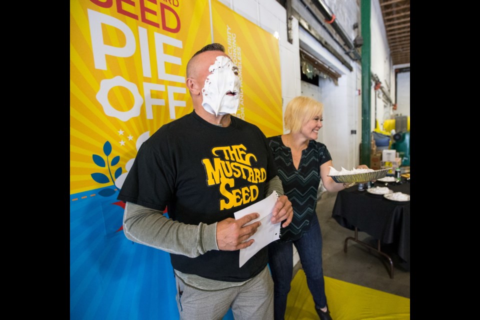 Bruce Curtiss gets a pie in the face from Janine Boice during the launch of Mustard Seed's Pie-Off Challenge.