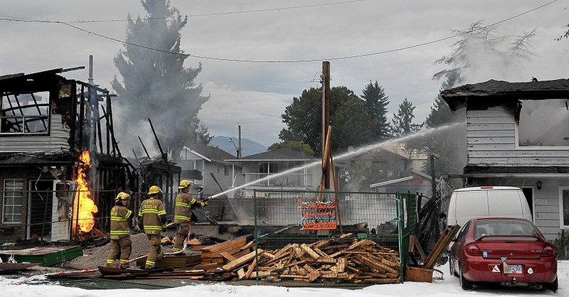 MARIO BARTEL/THE TRI-CITY NEWS
Port Coquitlam firefighters douse hotspots at a fire on Fraser Avenue early Tuesday morning that destroyed three houses, including one that was under construction. Nobody was hurt in the fire.