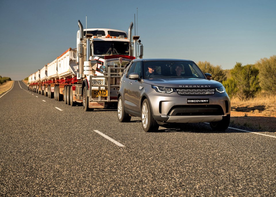 A Land Rover Discovery tows a seven-trailer road train – weighing approximately 110,000 kilograms –