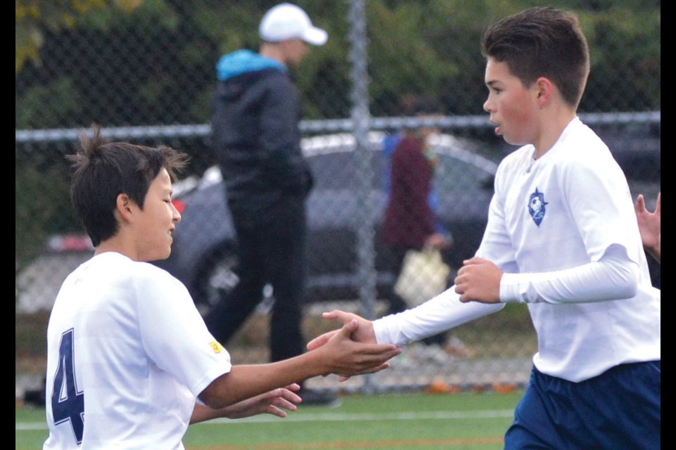 Richmond Strikers celebrate a goal on their way to a win over KLM and capturing the U14 Gold Division at the 25th annual Richmond Boys Soccer Thanksgiving Tournament.