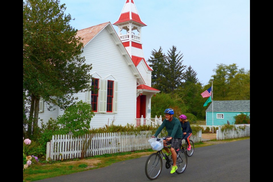 Cyclists pass the old Oysterville Church, a gift from founding father R.H. Espy, who donated the land and money for construction in 1892.