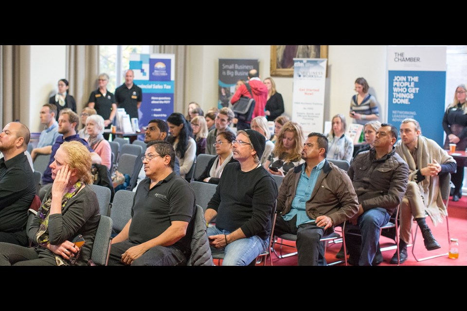 People listen to speakers during the Small Business Provider Information Session at Victoria City Hall.