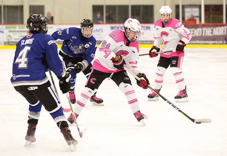 Cariboo Cougars forward Tanner Bahm puts a shot on goal against the South Island Royals on Saturday during the Cariboo Cougars annual Pink in the Rink game. Citizen Photo by James Doyle