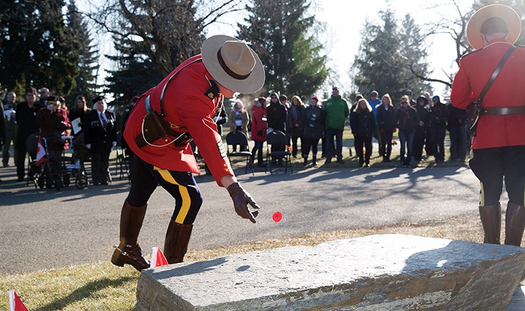 A member of the RCMP lays a poppy on Sunday at Memorial Park Cemetery during a Veterans Memorial Service. Citizen Photo by James Doyle