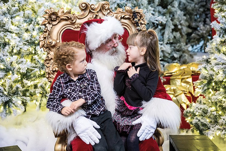 Victoria Lorrain, 6, (right), and Taylor Lorrain, 3, (left) meet with Santa Claus on Saturday morning at Pine Centre Mall. Citizen Photo by James Doyle