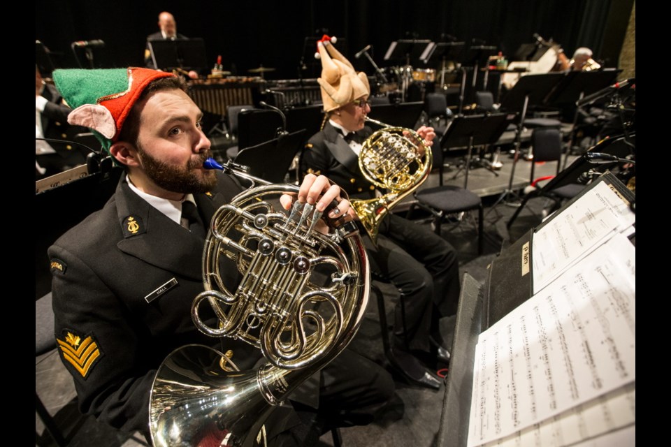 French horn players Petty Officer 2nd class Brian Hall and Petty Officer 2nd class Allison Zaichkowski warm up before the show.