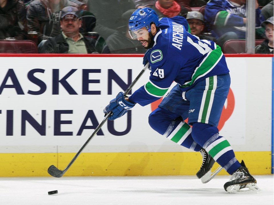 Darren Archibald skates the puck up ice for the Canucks in the preseason.