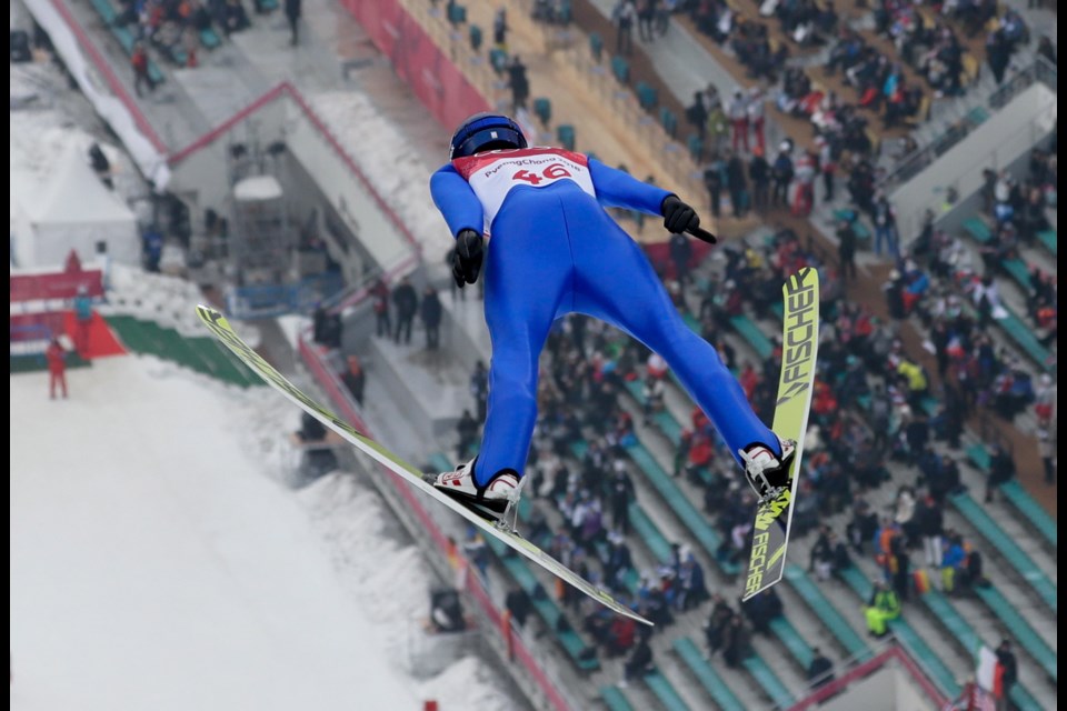 Joergen Graabak, of Norway, soars through the air during the trial jump in the nordic combined competition at the 2018 Winter Olympics in Pyeongchang, South Korea, Wednesday, Feb. 14, 2018.