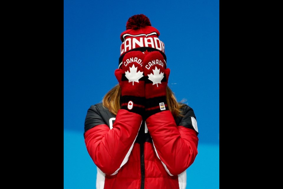 Women's 500-metre short-track speedskating bronze medalist Kim Boutin, of saʴý, reacts during the medals ceremony.