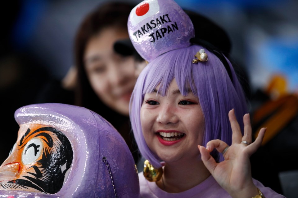 A fan of the Japanese speedskaters waits for the start of the mass start speedskating races at the Gangneung Oval at the 2018 Winter Olympics in Gangneung, South Korea, Saturday, Feb. 24, 2018.