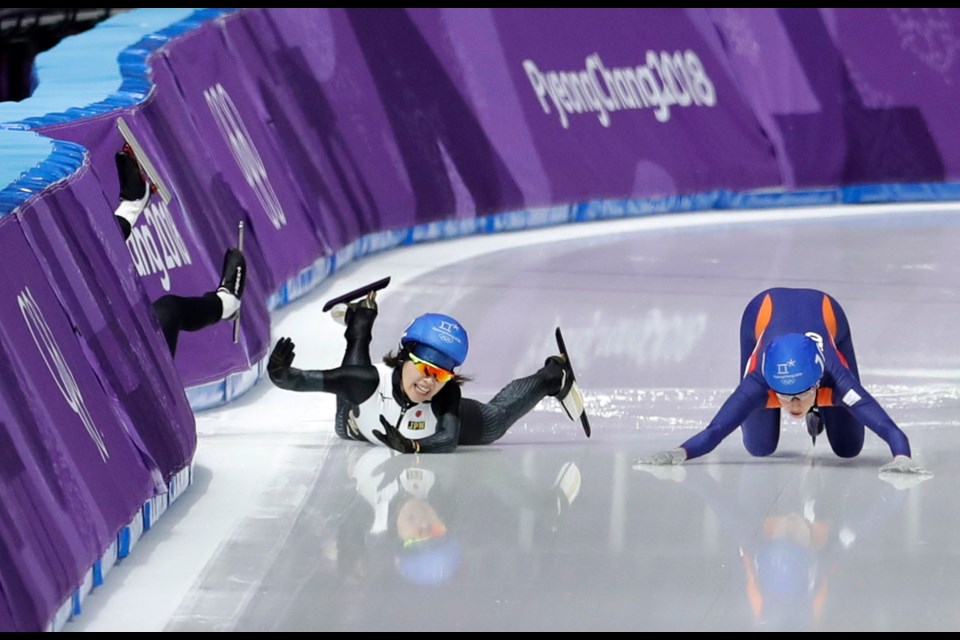 Ivanie Blondin of Canada, Ayano Sato of Japan, and Annouk van der Weijden of The Netherlands, from left to right, crash during the women's mass start speedskating race at the Gangneung Oval at the 2018 Winter Olympics in Gangneung, South Korea, Saturday, Feb. 24, 2018.