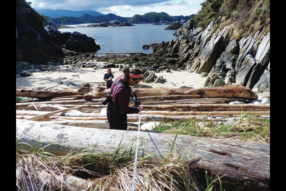 Researchers Sara Wickham, foreground, and Beatrice Proudfoot measure a pocket beach on one of a chain of small islands off the Great Bear Rainforest as part of a study into how nutrients from the sea affect the ecology on land. An Ideafest event on Monday sheds light on the researchers&Otilde; work.