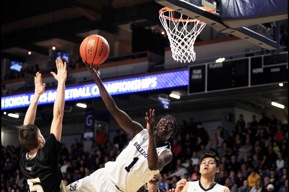 The Byrne Creek Bulldogs pushed an incredible season right to the provincial 3-A basketball final before falling 74-66 to South Kamloops. Above, Grade 11 guard Bithow Wan, goes for a layup with teammate Tyrill Whitebear watching.