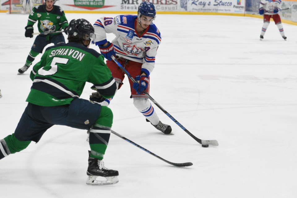 Ben Brar of the Spruce King carries the puck in on Surrey Eagles defenceman Cody Schiavon during Game 2 action Saturday night at Rolling Mix Concrete Arena. The Eagles won 3-2 to tie the best-of-seven BCHL Mainland Division final series 1-1.