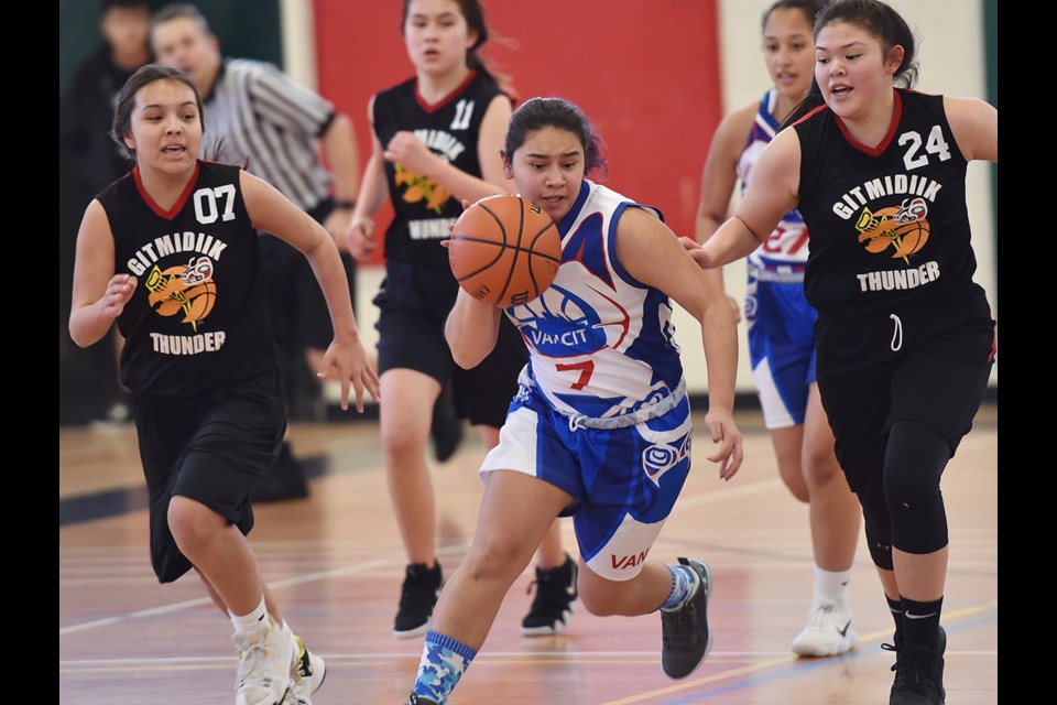 Vancity Reign's Mariela Frank Hernandez (middle) brings the ball up court during Wednesday's 62-25 win over the Gitmidiik Thunder at Britannia secondary. The Reign have advanced to Thursday's semifinal game in the Junior All Native Provincial Tournament.