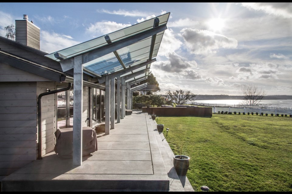 This 3,000-square-foot home overlooks Washington state&Otilde;s Puget Sound. All along the water-facing wall are sparkling French doors to the sprawling deck, itself protected, but not darkened one bit, by an artful overhang.