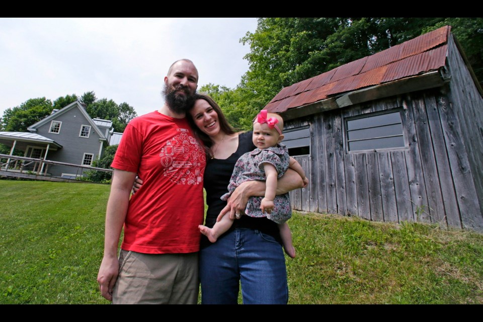 Nate and Elizabeth Willard Thames with their daughter Stella at their home in Vershire, Vermont. The couple, who became known as the Frugalwoods, decided to save most of their income and move from expensive Cambridge, Massachusetts, to live simply on a homestead in the woods.